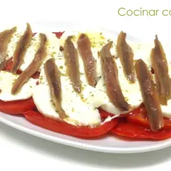 Ensalada caprese con anchoas, un toque salado que realza el sabor fresco de los tomates y la mozzarella. ¡Perfecta para compartir!